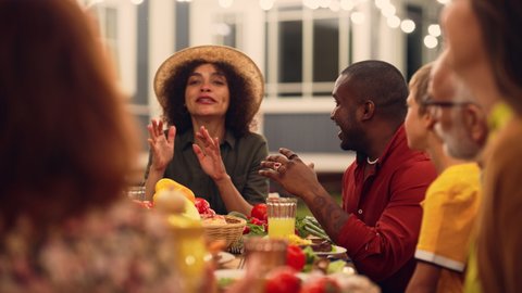 Portrait of an Excited Young Middle Eastern Female Sharing Stories, Joking, Laughing, Having Fun with Diverse Relatives and Multiethnic Friends During an Outdoors Dinner Table. Clinking Glasses. Adlı Stok Video