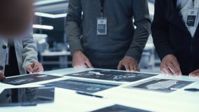 Executive Office Meeting of Chief Engineers Discussing Important Data Points of Their Latest Industrial Manufacturing Production of New Equipment. Managers DIscussing Blueprints on a Table - Powered by Shutterstock - Get 15% off with code: PIKWIZARD15