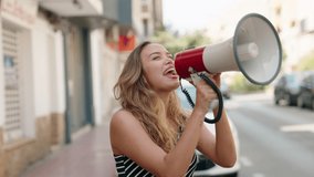 Young beautiful hispanic woman using megaphone screaming at street - Powered by Shutterstock - Get 15% off with code: PIKWIZARD15
