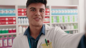 Young hispanic man pharmacist having video call at pharmacy