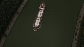 Aerial video of a gas transport ship seen on Danube. Footage was taken from a drone at a higher altitude with camera pointed downward to keep the ship in focus for top shot.