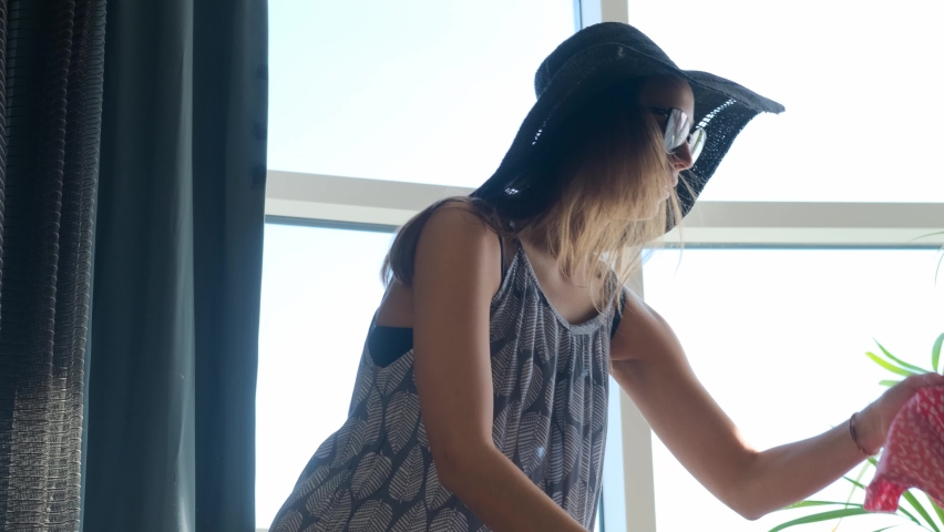 Summer holidays, voyage and traveler concept - Young beautiful woman collects a suitcase on a summer travel