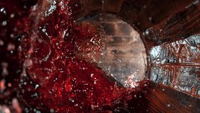 Super Slow Motion Shot of Red Wine Splashing in Old Oak Wooden Barrel at 1000fps.