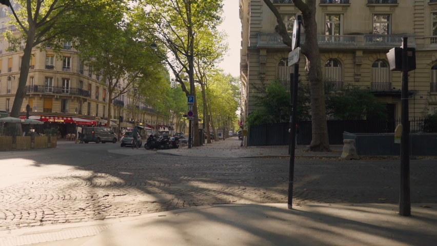 Attractive woman crossing the road in a quiet street in Paris