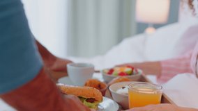 Breakfast, bed and couple people with healthy food for morning nutrition, diet and wellness at home. Man giving fruits, salad and orange juice to woman for birthday love, care and support in bedroom - Powered by Shutterstock - Get 15% off with code: PIKWIZARD15