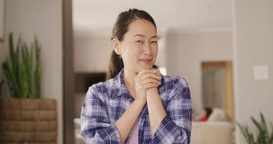 Video of happy asian woman having video call. Lifestyle, relax, spending time at home with technology concept.