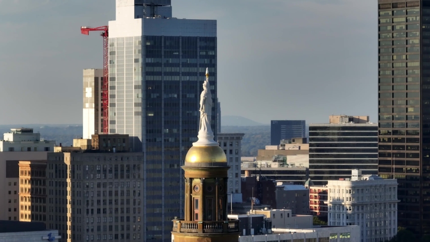 Atlanta , Georgia , United States - 10 24 2022: Atlanta skyscrapers in downtown. Georgia's Own, Westin Hotel, highrise buildings with State Capitol dome and statue. Long aerial zoom.