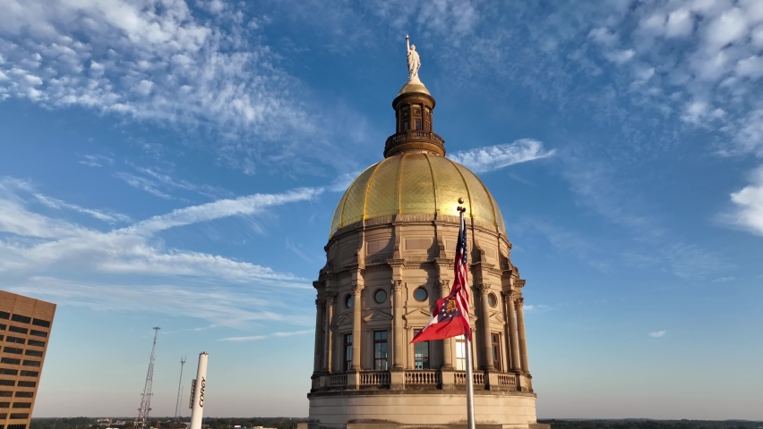 Atlanta , Georgia , United States - 10 24 2022: Capitol dome building. US and State of Georgia flags on skyline in Atlanta GA. Aerial.