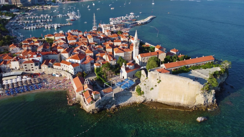 Aerial drone rotating view of Budva old medieval town and citadel in Montenegro Royalty-Free Stock Footage #1096362617