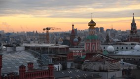 Moscow cityscape at sunset. Panoramic view of rooftops in downtown district with Moscow Kremlin and Saint Basil's Cathedral. Real time video. Selective focus. Travel in Russia theme.