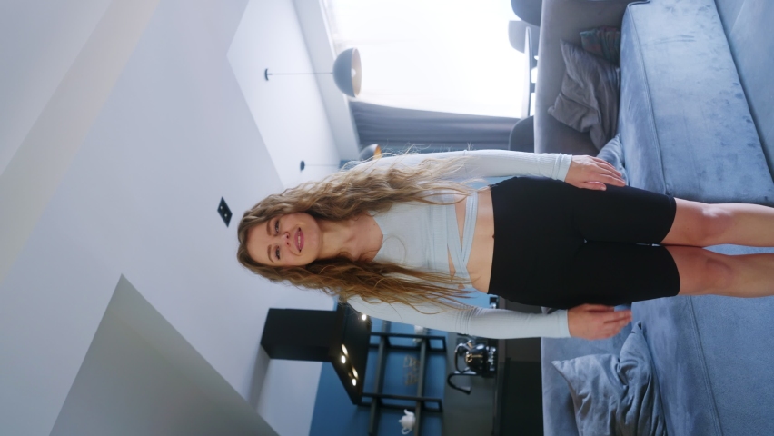 Blogger girl recording vertical pov video of trendy dance challenge on social media platform for likes, followers. Woman funny dancing, filming performance for stories on smartphone at home studio. Royalty-Free Stock Footage #1096368155