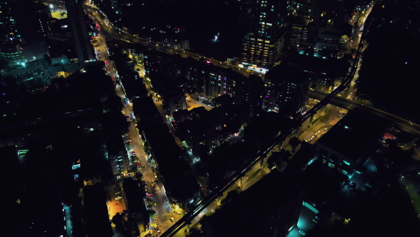 4K Aerial night footage of a busy traffic intersection illuminated with cars and street lights. Mumbai Skyline, Maharashtra, India. Indian City Mumbai at night