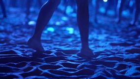 Closeup view of woman legs dancing at open air concert held on the beach at summer night. Lady is having fun and enjoying at the disco moving in the darkness. Atmosphere of excitement at music concert - Powered by Shutterstock - Get 15% off with code: PIKWIZARD15