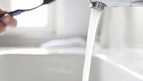 Person hand with toothbrush under water steam closeup. Hygiene routine and tooth care - Powered by Shutterstock - Get 15% off with code: PIKWIZARD15