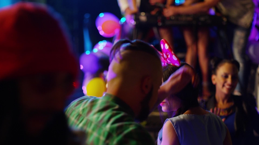 Footage of a crowd or group of young, stylish multi-ethnic people during colorful party in different clothes . Dancers having fun dancing at a party . Shot on RED HELIUM Cinema Camera in slow motion . Royalty-Free Stock Footage #1096374601