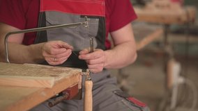 a man installs a blade in a manual jigsaw. slow motion video