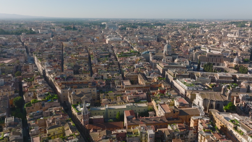 Backwards fly above old town, narrow streets and historic buildings in city. Revealing Terrazzo del Pinkie with views on landmarks. Rome, Italy