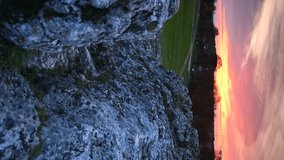 VERTICAL VIDEO, Limestone rocks against the backdrop of a strongly colored sunset sky
