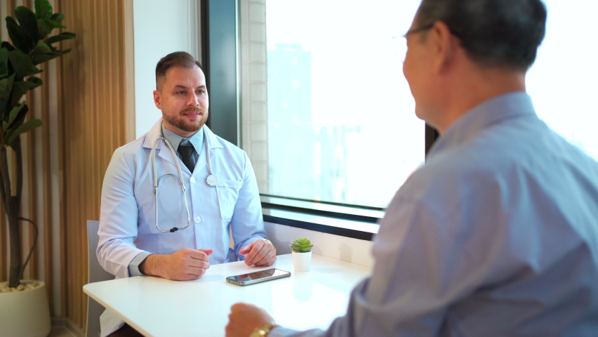 Doctor and senior Asian businessman making a handshake after finish the conversation. Senior Asian businessman talking to doctor at customer lounge or lobby in hospital. Health and wealth concept. - Powered by Shutterstock - Get 15% off with code: PIKWIZARD15