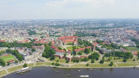 Inscription on video. Krakow, Poland. Wawel Castle. Ships on the Vistula River. View of the historic center. Shimmers in colors purple, Aerial View, Point of interest