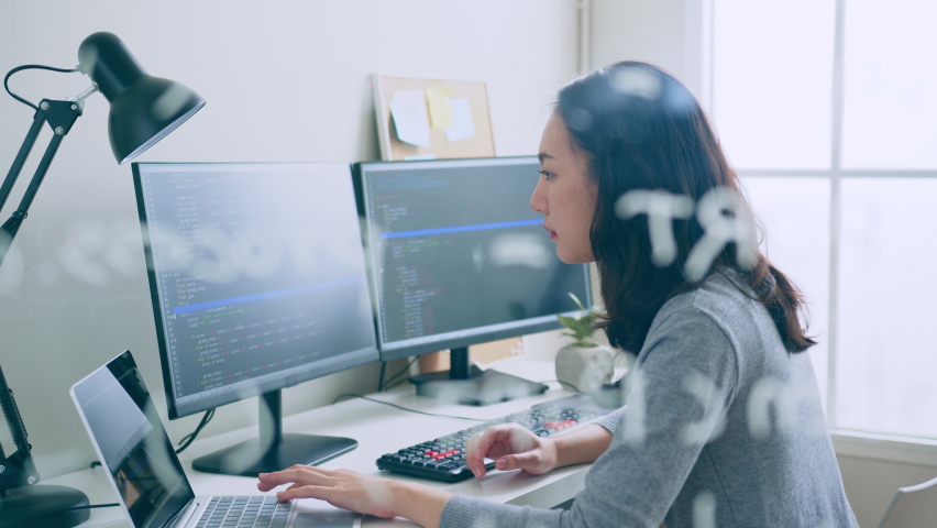 Young Asian woman, developer programmer, software engineer, IT support, working hard on computer to check coding in bugging system | Shutterstock HD Video #1096419617