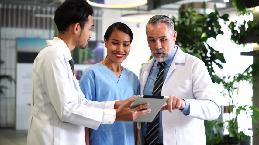 Senior doctor professors talk to nurses and interns to discuss patient care and care for the quality of inpatient services in hospitals. Royalty-Free Stock Footage #1096421067