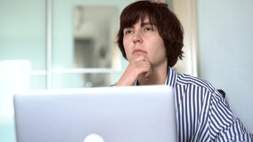 Young caucasian brunette businesswoman indoor at home office typing on computer keyboard, looking at side thinking. Home working, isolation, educating or online working concept. High quality 4k video