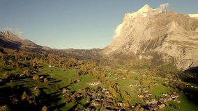 aerial drone footage pushing in over village of Grindelwald at sunset