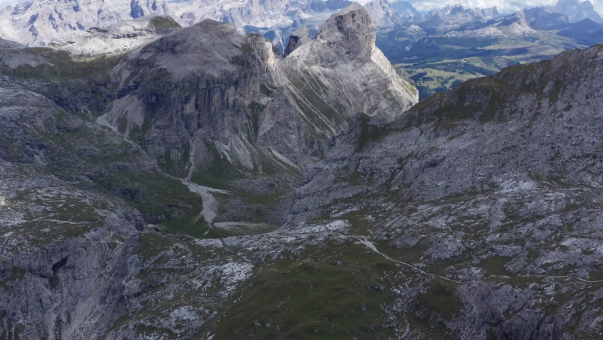 Aerial drone landscape of the meadows at high altitudes, forming gentle hills. Gardenaccia massif in the background. Dolomites, Alta Badia, Sud Tirol, Italy