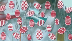 Animation of easter eggs over caucasian male scientist with beakers. Global science and digital interface concept digitally generated video.