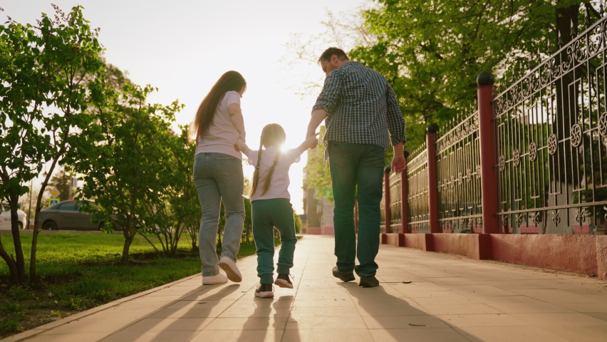 happy family. mother father child run through park sunset. mom dad kid fun running sun. view from back. happy family park. chidhood dream. family walk with kid around city playing. run teamwork Royalty-Free Stock Footage #1096433535