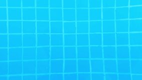 Small tile ripples under the pool water, slow motion (background video).