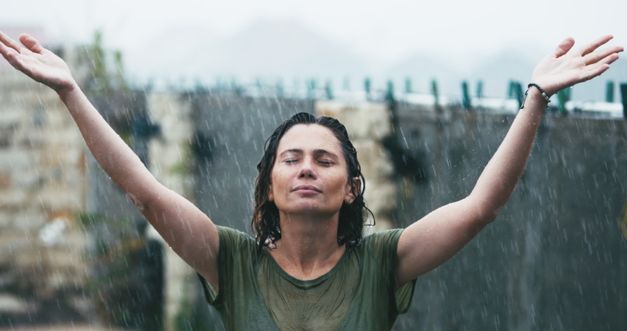 Caucasian Female standing in the rain. Inspired meditating woman 40