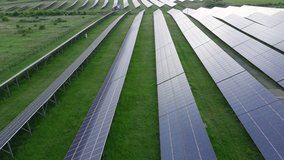 Solar panels to generate energy from the sun's rays are installed in the meadows under a blue sky