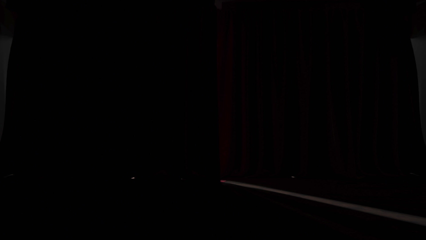 Cinematic shot of empty theatre with red velvet curtains opening from behind the stage Royalty-Free Stock Footage #1096446401