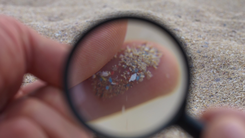 Microplastic contamination on the beaches worldwide. Micro plastics visual identification under a magnifier. Small plastic particles in sand. Environment, plastic pollution, oceans | Shutterstock HD Video #1096446985