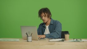 Young Disappointed Multicultural Freelancer Student Covers Face and Mouth with Palms in Frustration,While Getting Bad News on Laptop. Looking around for Solving the Problem on Green Screen Background