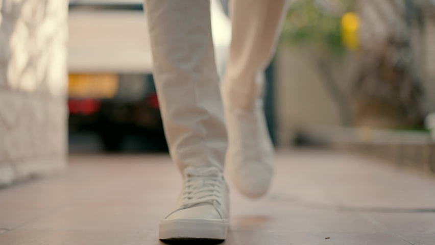 A man walking in white shoes Royalty-Free Stock Footage #1096450171