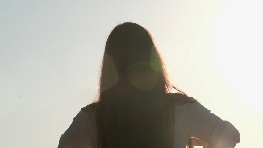 girl relaxing with open arms towards the sun