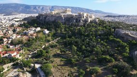 Aerial drone cinematic video of iconic Acropolis hill and the Parthenon a Unesco World Heritage Masterpiece of ancient times, Athens historic centre, Attica, Greece
