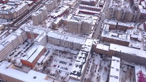 Winter city with high-rise buildings. Clip.View from a helicopter on a city with narrow streets and tall houses