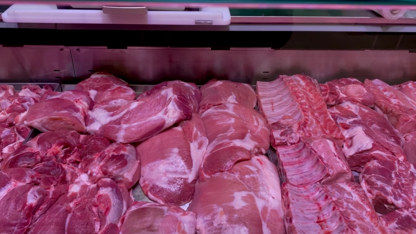 Different juicy and quality raw meat on counter for sale in butchers shop. Royalty-Free Stock Footage #1096460271