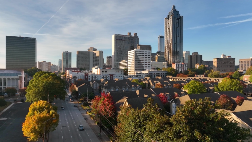 Downtown Atlanta Georgia housing in shadow of skyscrapers. Aerial in golden hour autumn light. Royalty-Free Stock Footage #1096466121