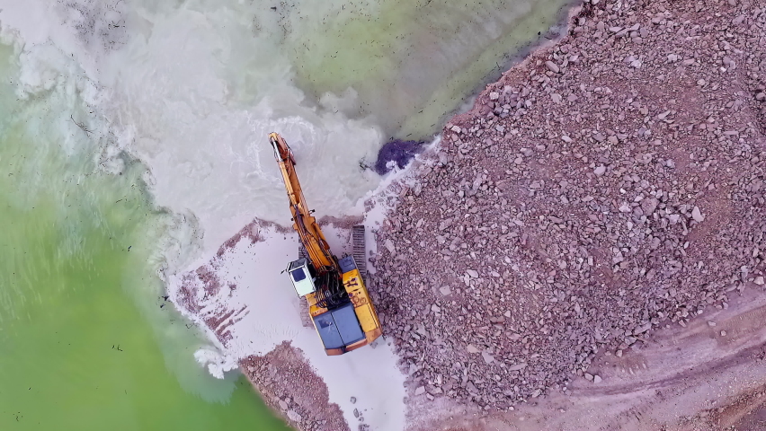 Overhead View Of Excavator Removing Stones And Dredging The River. - Drone Shot Royalty-Free Stock Footage #1096466765