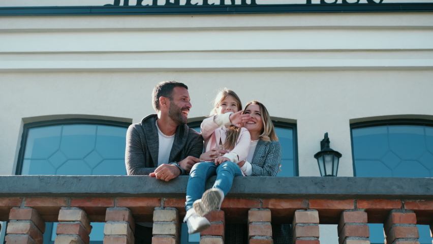 Cheerful family spends time on the terrace of their luxury house Royalty-Free Stock Footage #1096471639