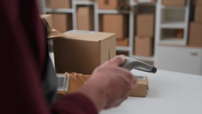 The process of scanning a barcode with a hand-held electronic scanner with a red laser beam, a warehouse worker keeps track of the parcels by scanning the goods of the parcel box
 - Powered by Shutterstock - Get 15% off with code: PIKWIZARD15