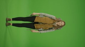 Vertical Video. Green Screen. Chroma Key. Woman Tourist in the Hands of With Tickets and Passport, With Big Travel Backpack, Experiencing Emotions Joy. Female on Vacation