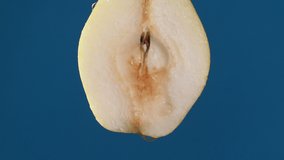 Yellow half pear on a blue dark background with drops of water rolling down the pear and flowing splashing with isolated background - Powered by Shutterstock - Get 15% off with code: PIKWIZARD15