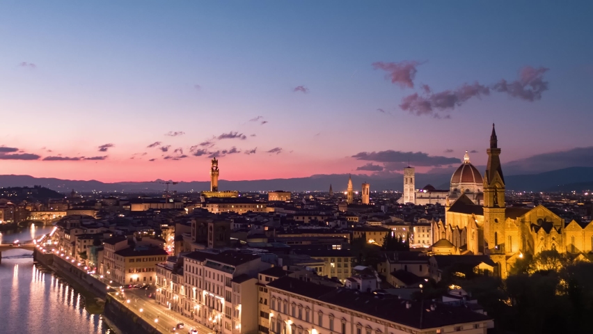 Aerial panoramic view of Florence Cathedral, Firenze Cattedrale di Santa Maria del Fiore, Ponte Vecchio illuminated and Arno River on a beautiful colourful sunset sky, Tuscany region of Italy Florence Royalty-Free Stock Footage #1096498095