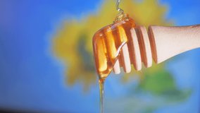 Honey Pouring From Honey Dipper. This clip shows Honey dripping on wooden honey dipper